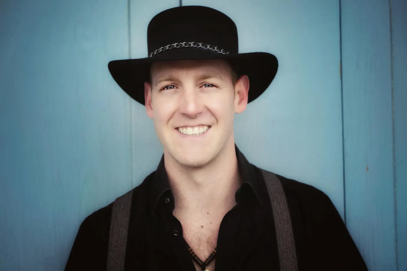 Portrait of Mike Low in front of a blue wooden wall